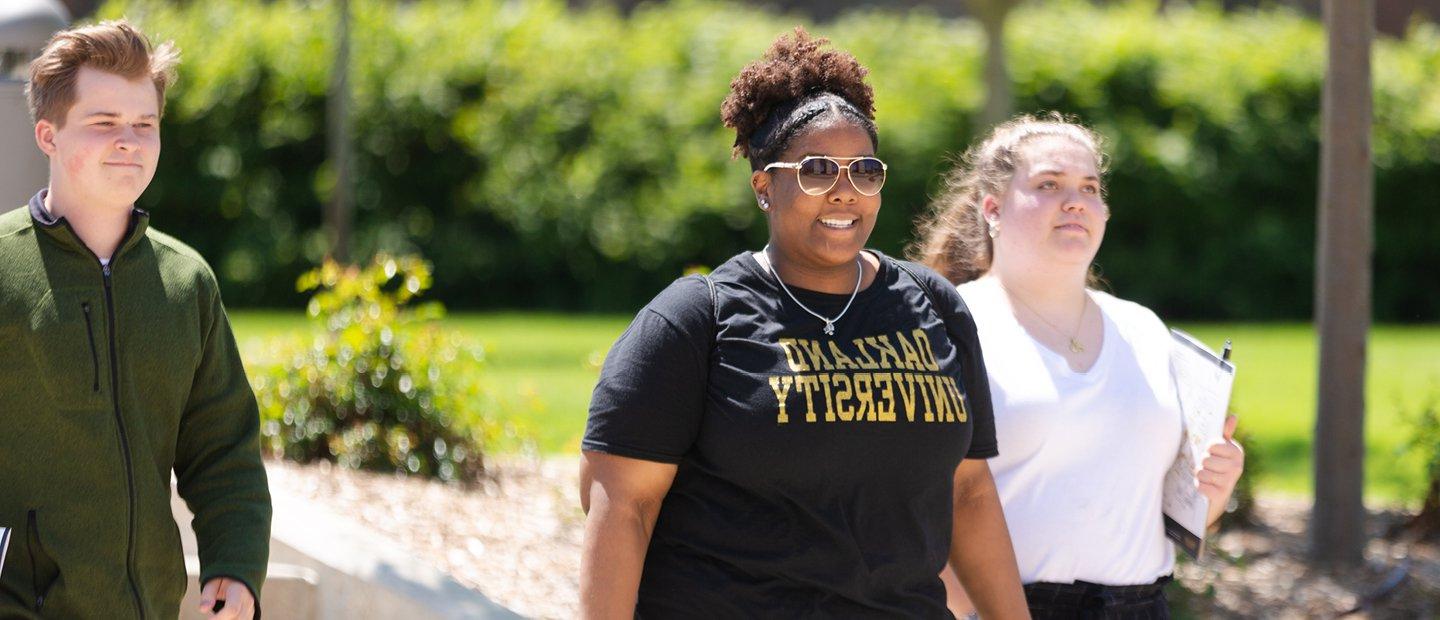 Students walking on Oakland University's campus in Summer.